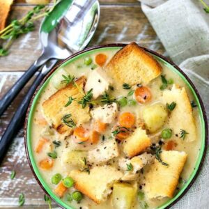 chicken pot pie soup with spoons on a wooden board