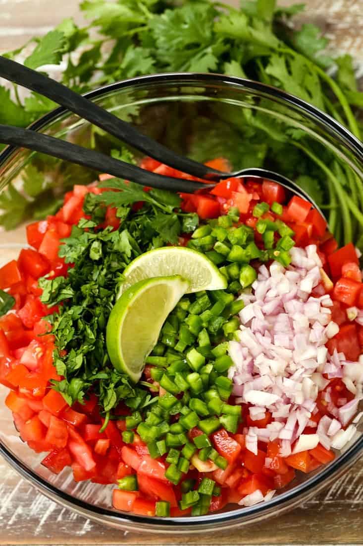 fresh salsa in a bowl with two spoons