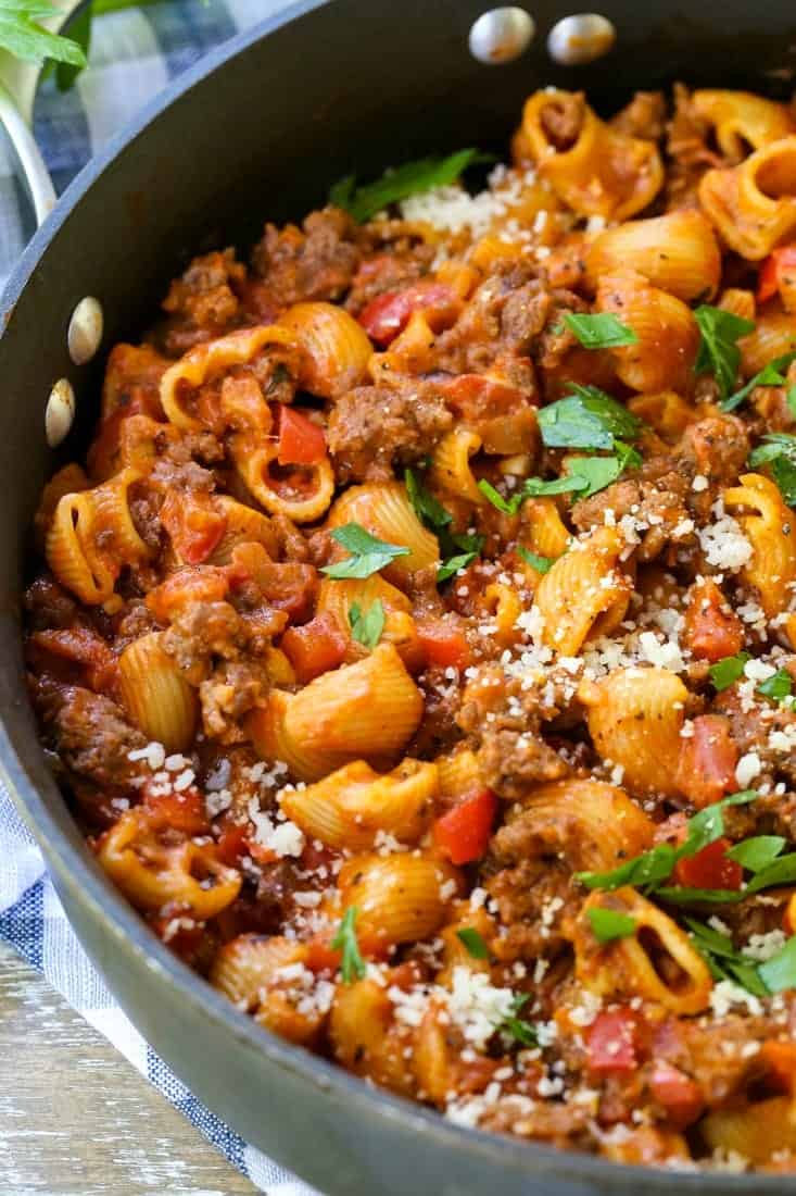beef goulash in a skillet with parmesan cheese