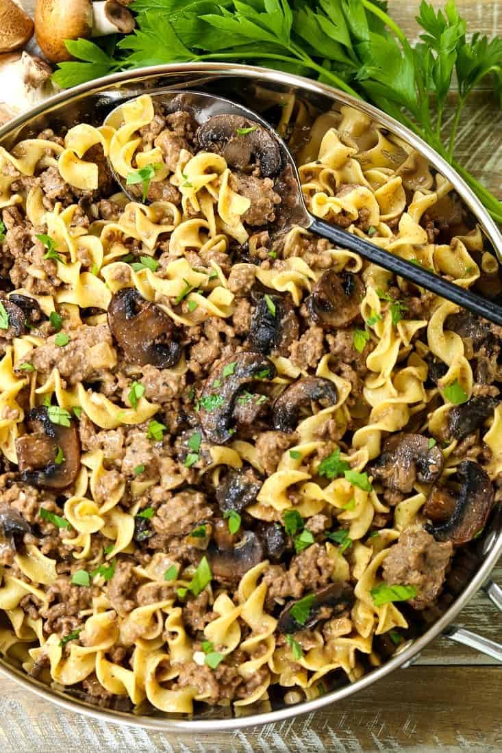 beef stroganoff mixed with noodles in a skillet
