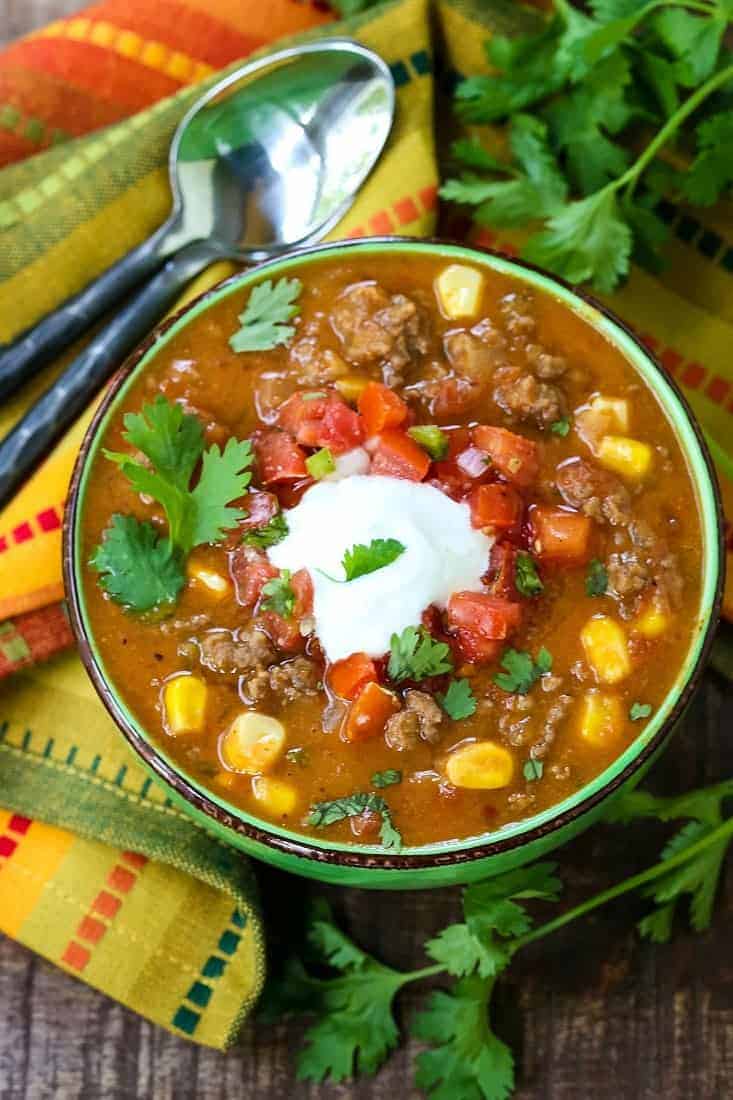 Taco soup in a bowl with a colorful napkin and a spoon