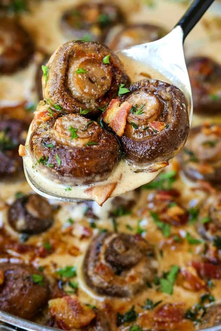 Our Creamy Bacon Mushrooms are cooked in the most addicting cream sauce! Spoon over steak or chicken, even makes an amazing pasta sauce! creamy bacon mushrooms in a spoon with sauce