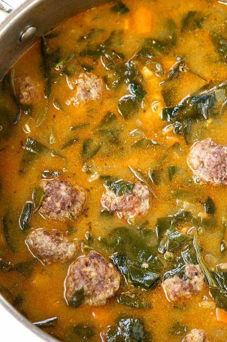 soup with meatballs and spinach in a pot