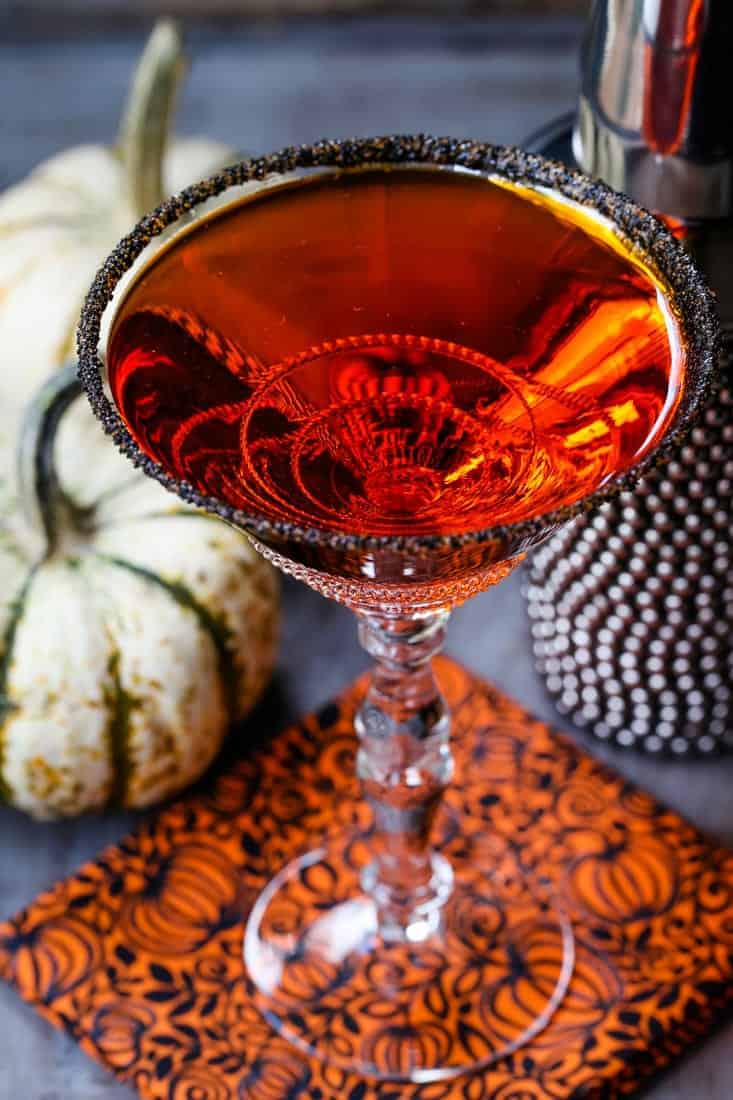 pumpkin drop martini with pumpkins in the background