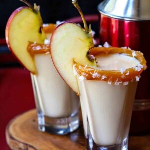 salted caramel apple shots with an apple slice for garnish