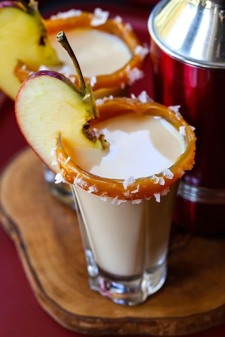 shot glass with a caramel rim and an apple slice