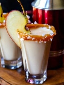 caramel apple shots with a shaker on a tray