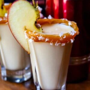 caramel apple shots with a shaker on a tray