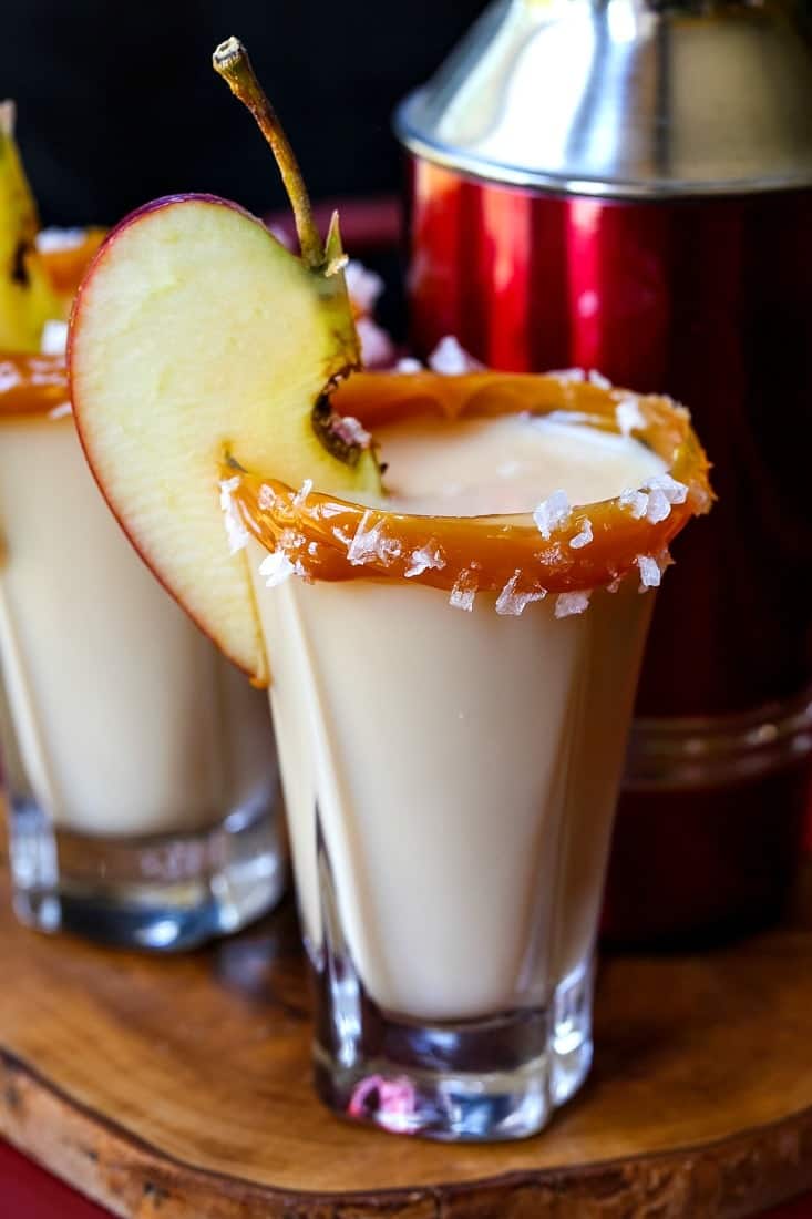 caramel apple shots with a shaker on a tray