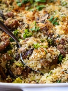 spoon of sausage and broccoli casserole in dish