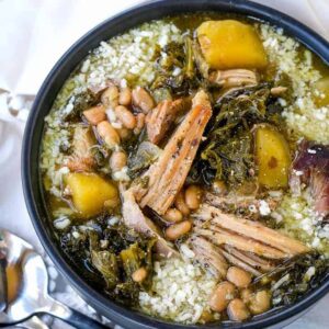 pork stew in a black bowl with spoons