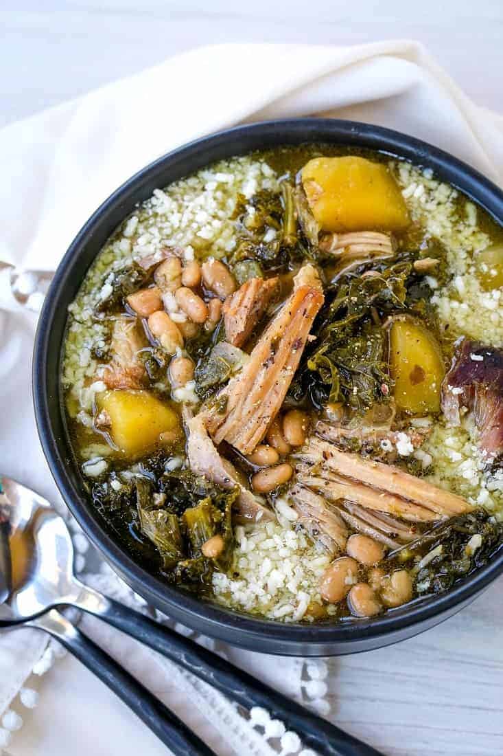 pork stewe in a black bowl with spoons