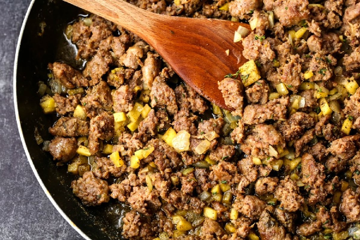 crumbled sausage and diced apples in skillet