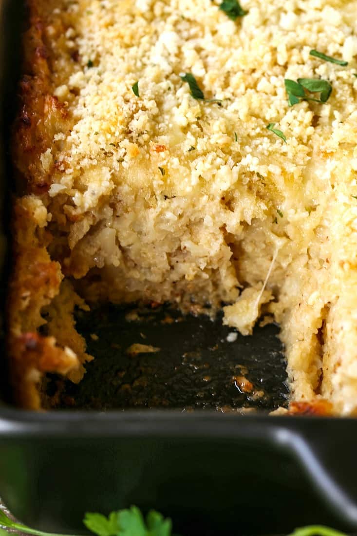 Parmesan Roasted Cauliflower Gratin with a scoop out of the dish