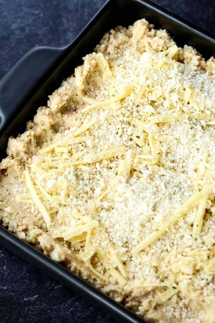 cauliflower gratin in a black baking dish before baking