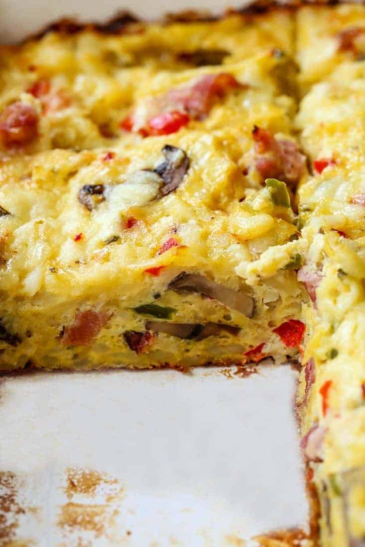 western hash brown casserole recipe in a baking dish with a slice out