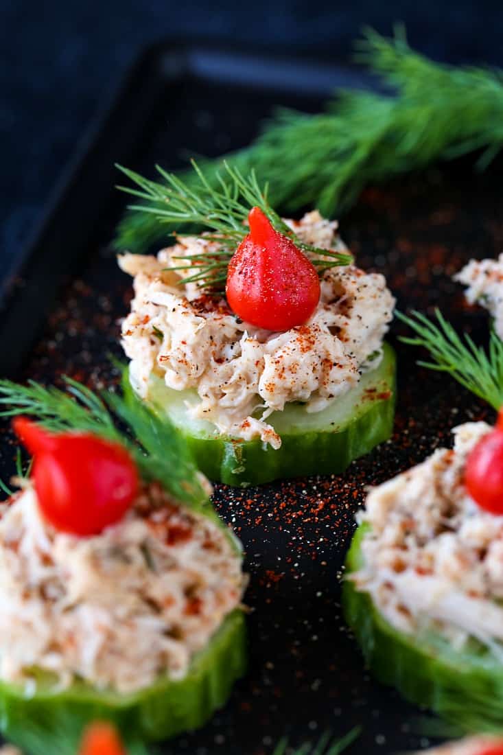 crab salad on top on cucumber slices with a red bell pepper