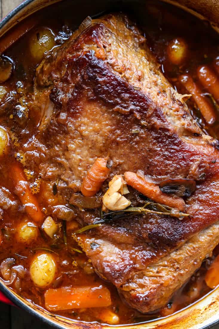 pot roast recipe with vegetables coming out of the oven