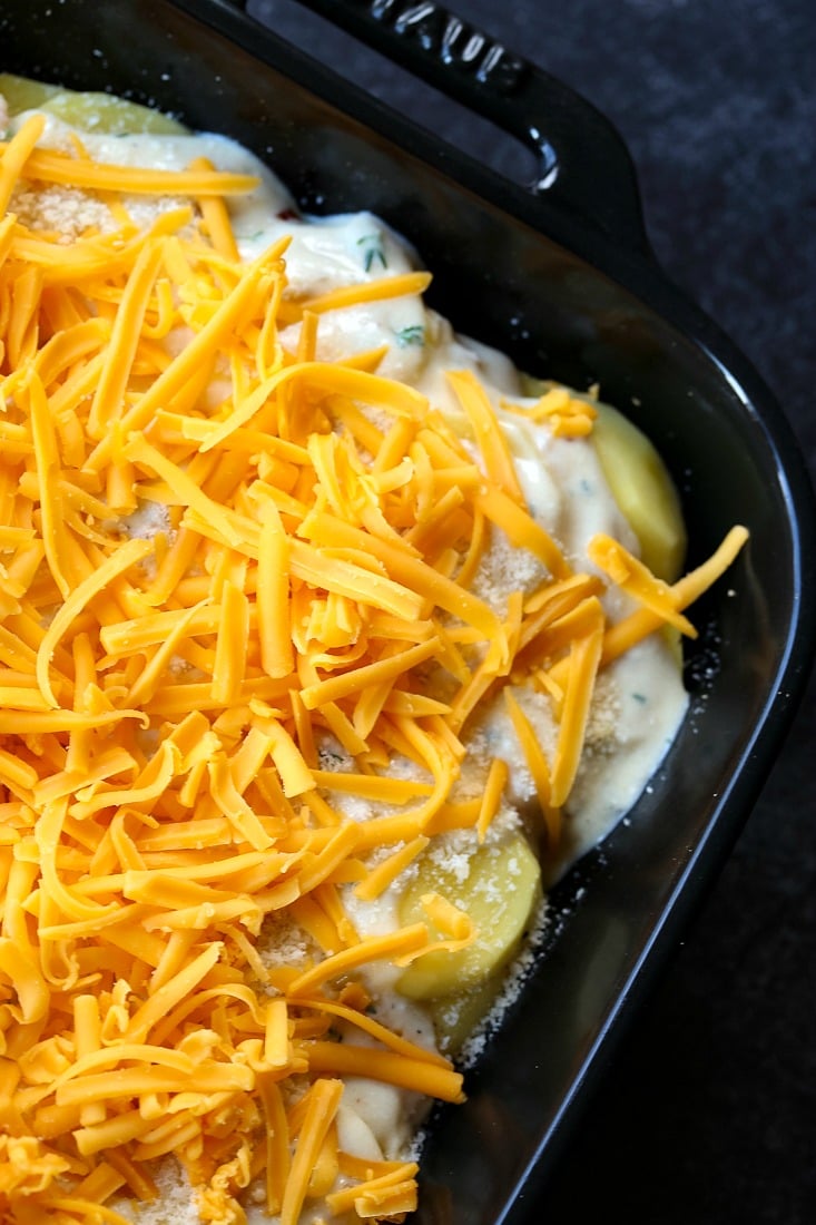 scalloped potatoes with a layer of cheese on top before baking