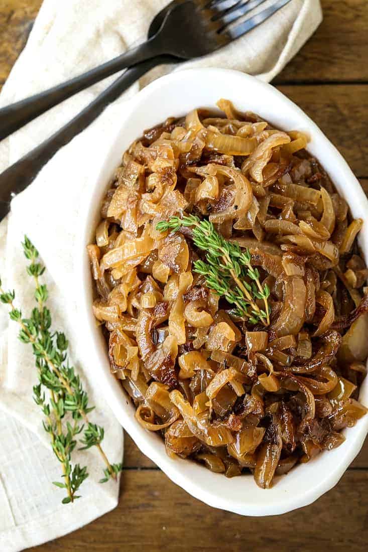 slow cooker caramelized onions in a white dish