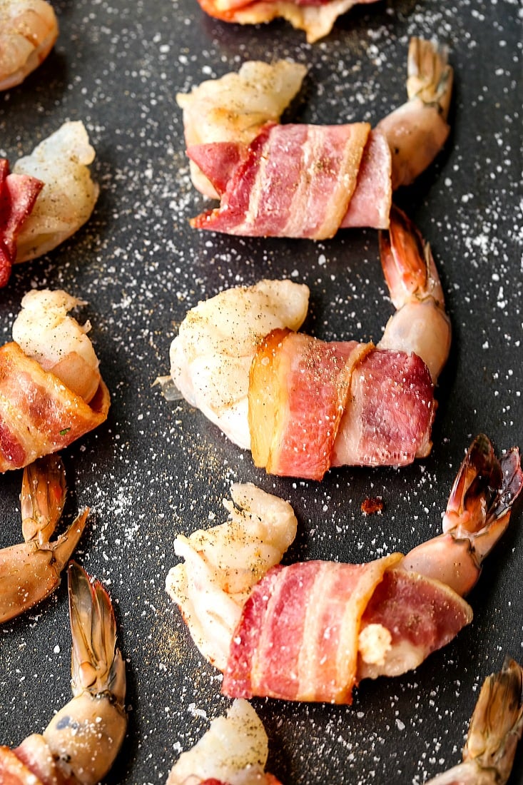 bacon wrapped shrimp on a baking sheet