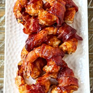 bacon wrapped shrimp on a white platter