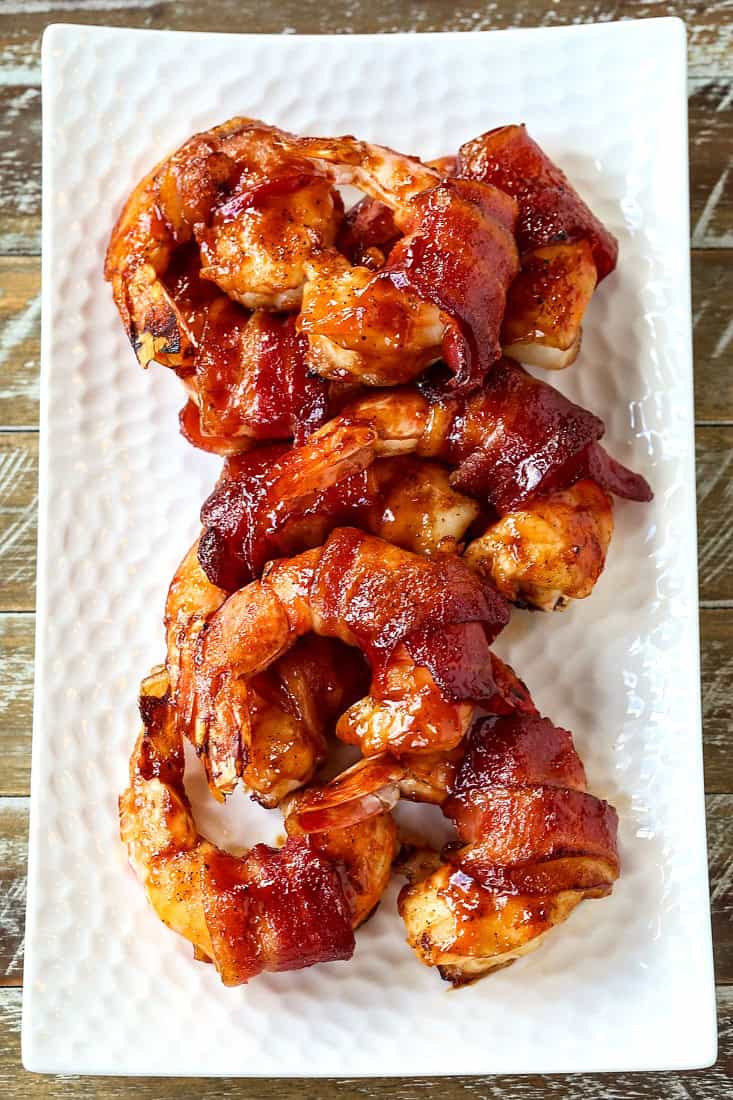 bacon wrapped shrimp on a white platter