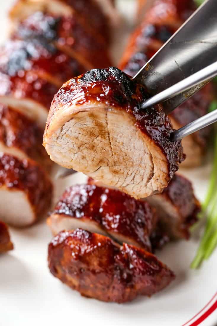 pork tenderloin slice with a large fork and knife