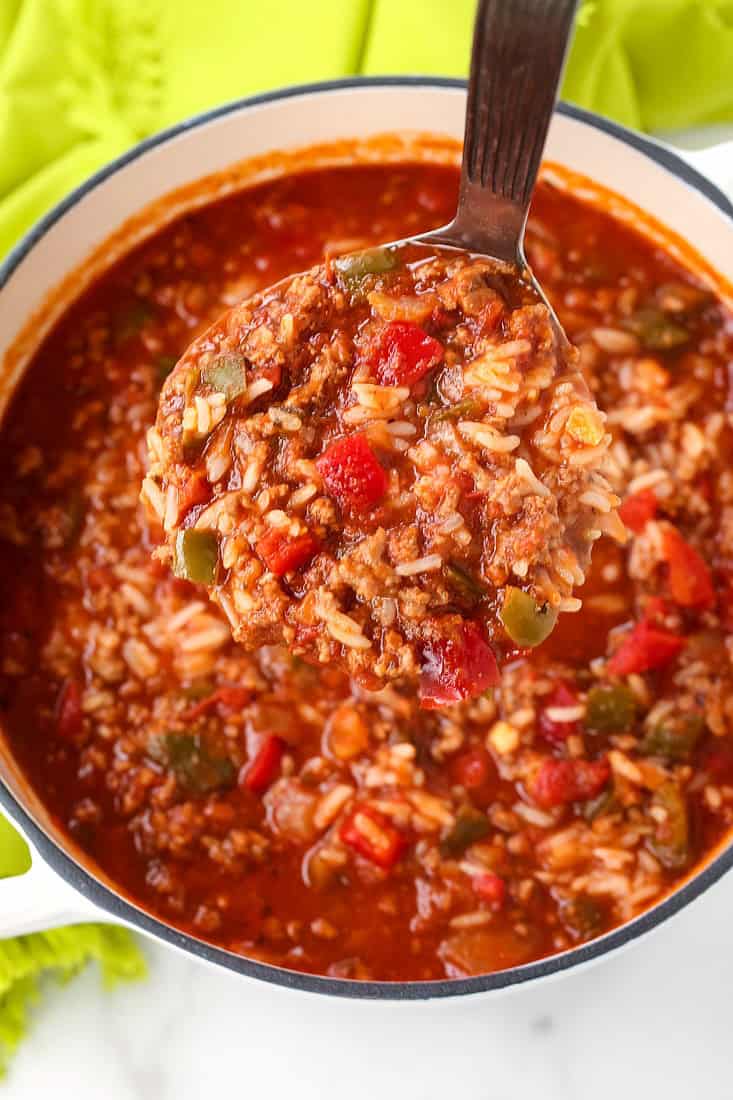 stuffed pepper soup recipe on a ladle over a pot