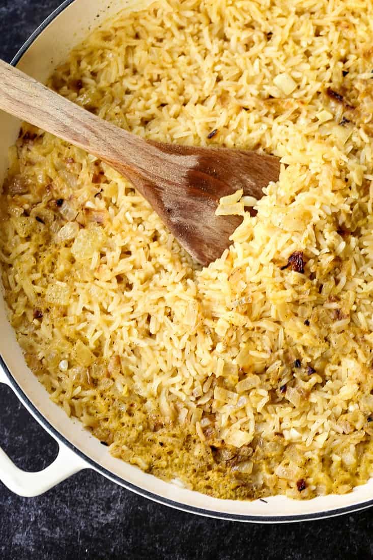 rice cooked in a dutch oven with chicken broth and onion