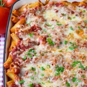 baked ziti in a casserole dish with tomatoes