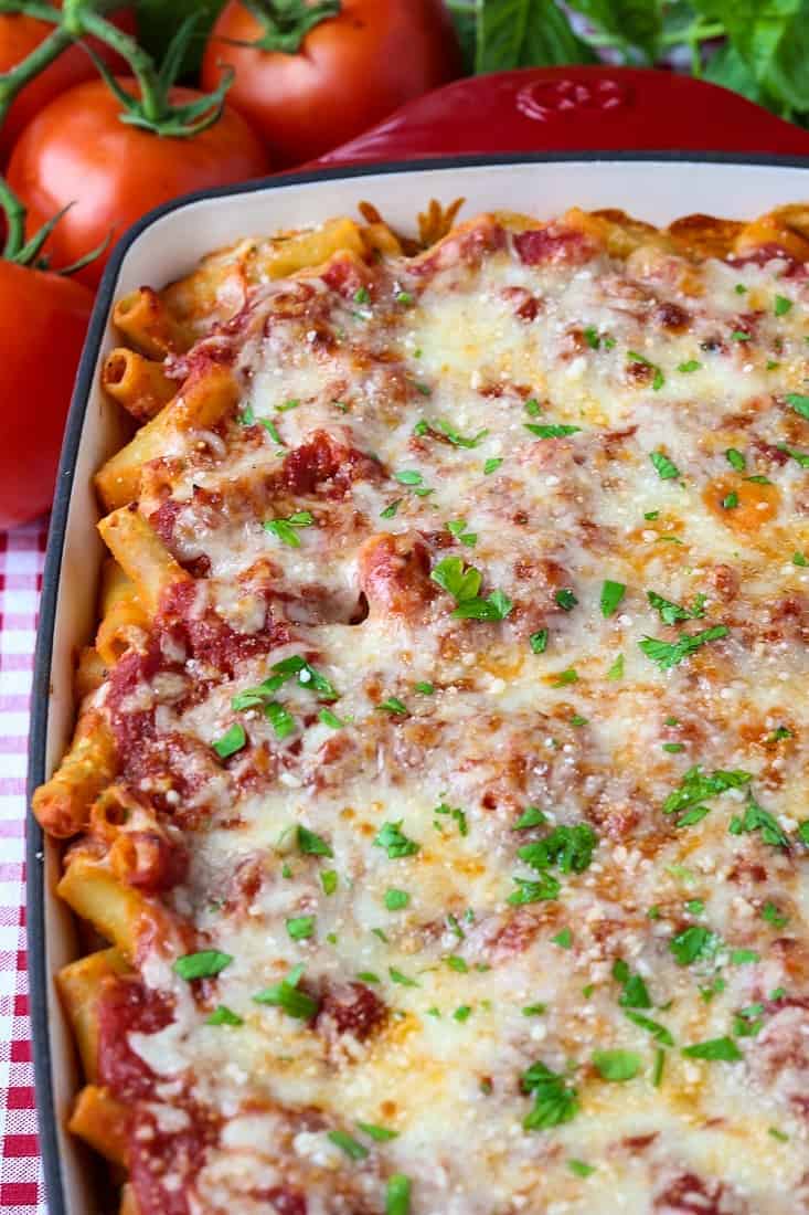 baked ziti in a casserole dish with tomatoes