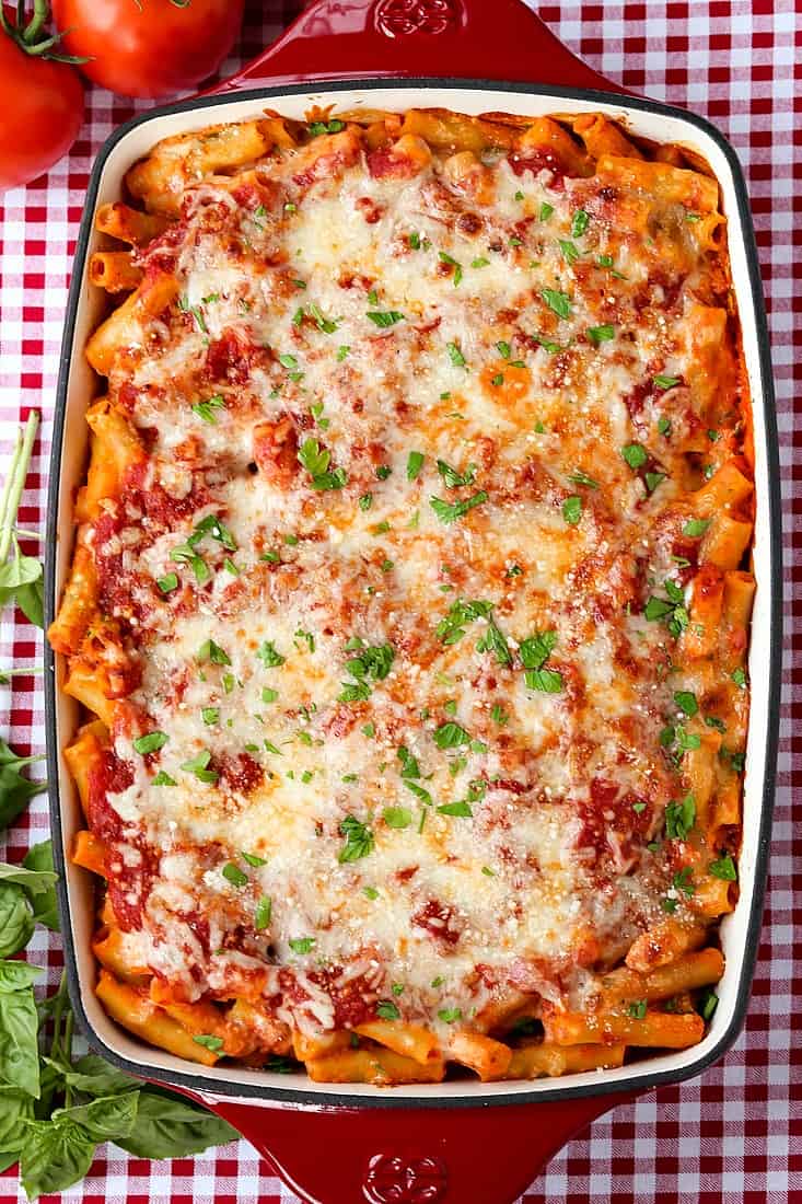 Holiday Dinner Ideas From Casual To Elegant are our favorite dinners to make for any holiday or party, date night at home or backyard BBQ's! baked ziti recipe on a red and white checkered table cloth