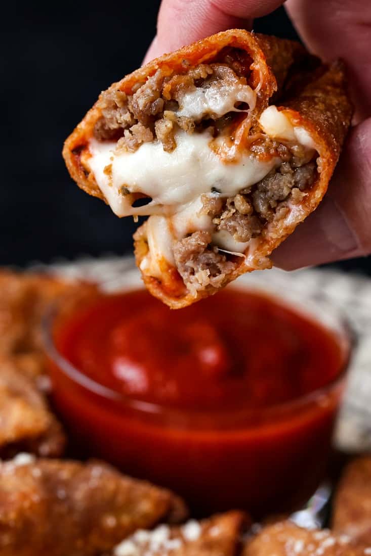 A copycat Totino's Pizza Roll with cheese and sausage that's been cut in half to show the filling.