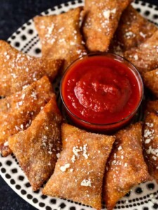 Copycat Totino's Pizza Rolls on a plate with tomato sauce for dipping.