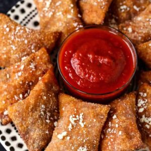 Copycat Totino's Pizza Rolls on a plate with tomato sauce for dipping.