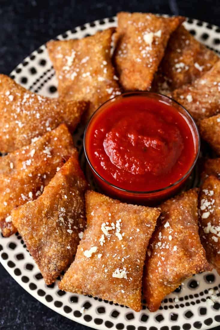 Copycat Totino's Pizza Rolls on a plate with tomato sauce for dipping.