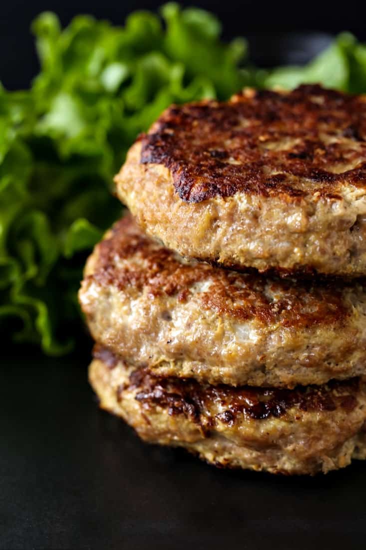 turkey burger patties stacked on a black plate