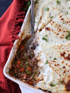 shepherd's pie in casserole dish with serving spoon