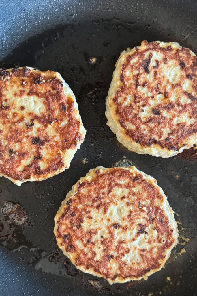 cooked turkey burger patties in skillet