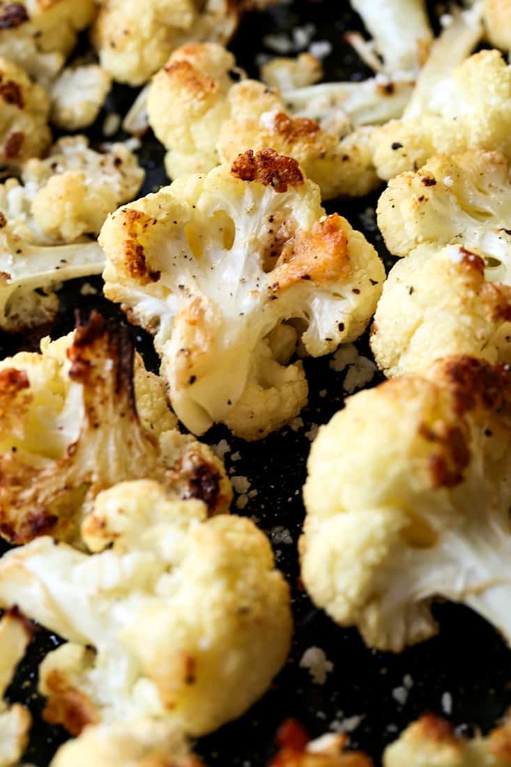 roasted cauliflower with parmesan cheese on a sheet pan