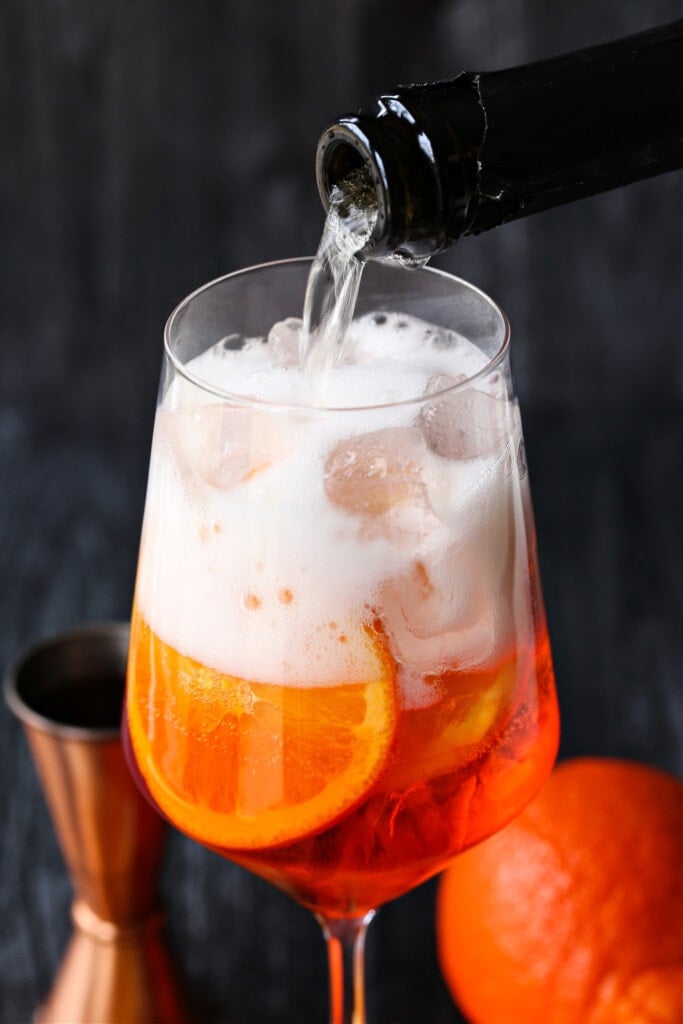 prosecco being poured into a glass for champagne cocktail