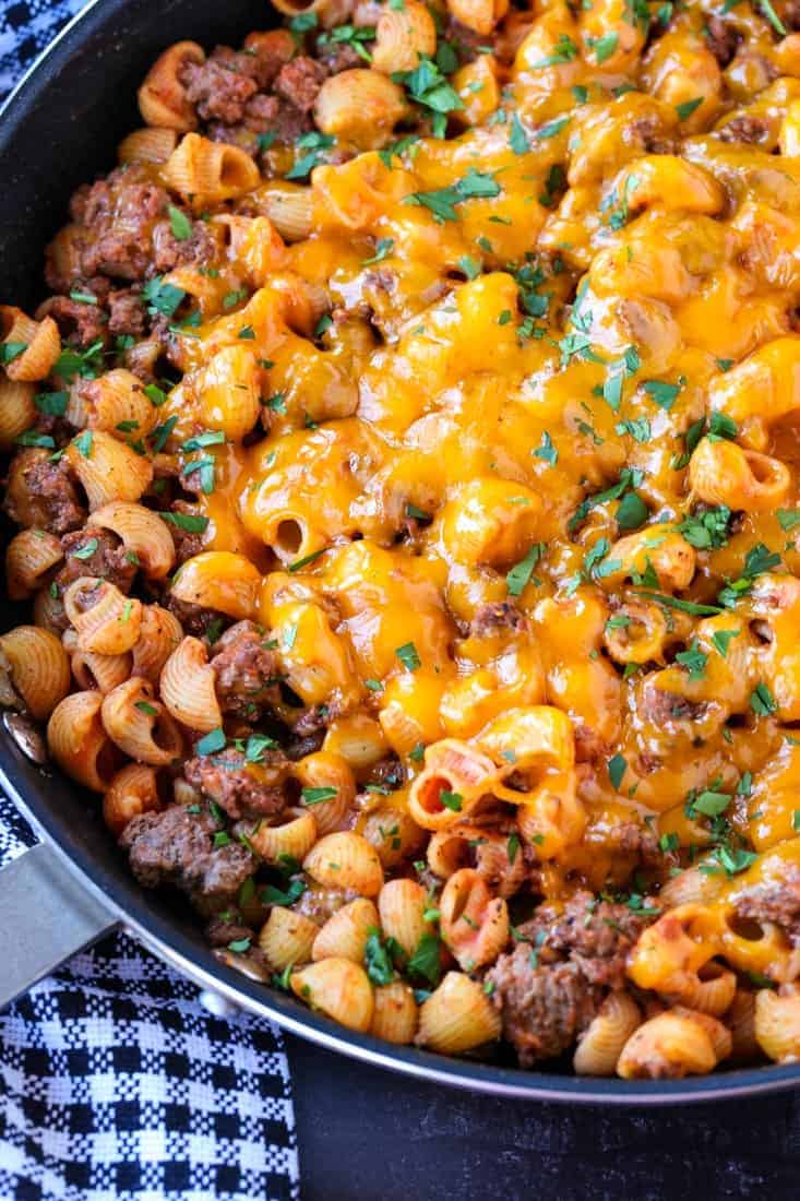 Cheeseburger pasta skillet in a pan with a checkered napkin