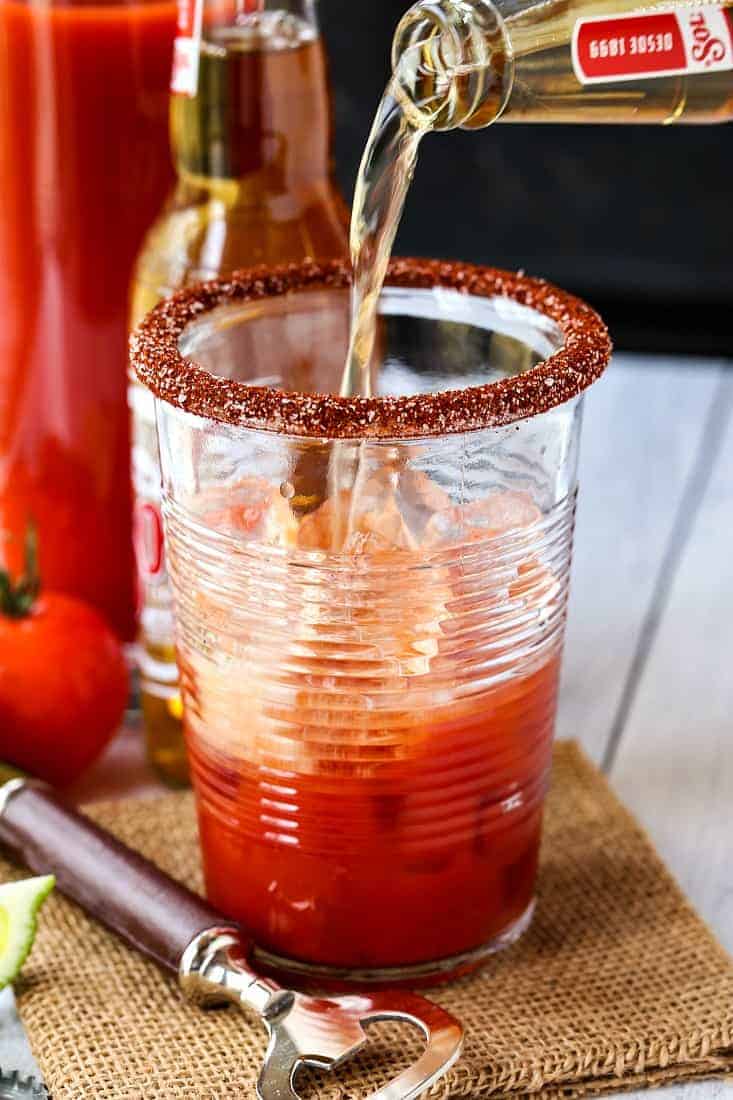 Beer pouring into a glass to make a Michelada