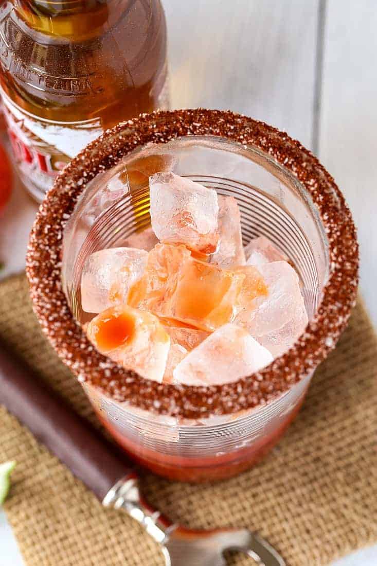 A spicy rim on a beer glass filled with ice