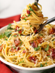 pasta carbonara twirled on a fork and spoon