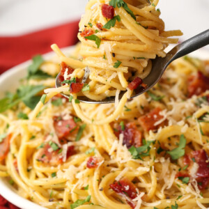 pasta carbonara twirled on a fork and spoon
