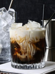 white russian cocktail with ice and metal shot glass