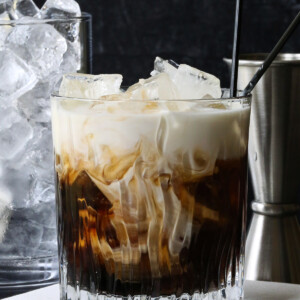 white russian cocktail with ice and metal shot glass