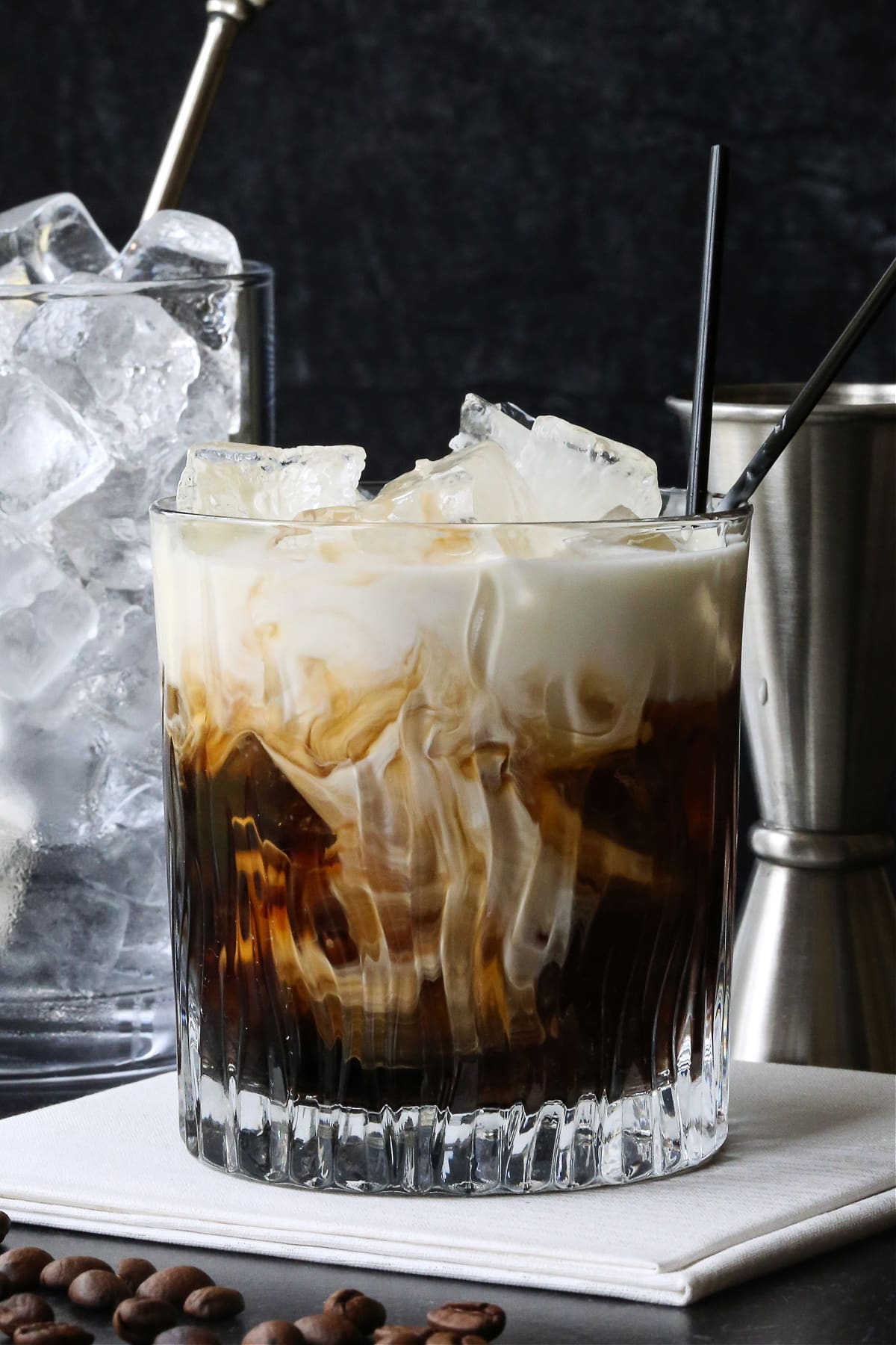 white russian cocktail with ice and metal shot glass